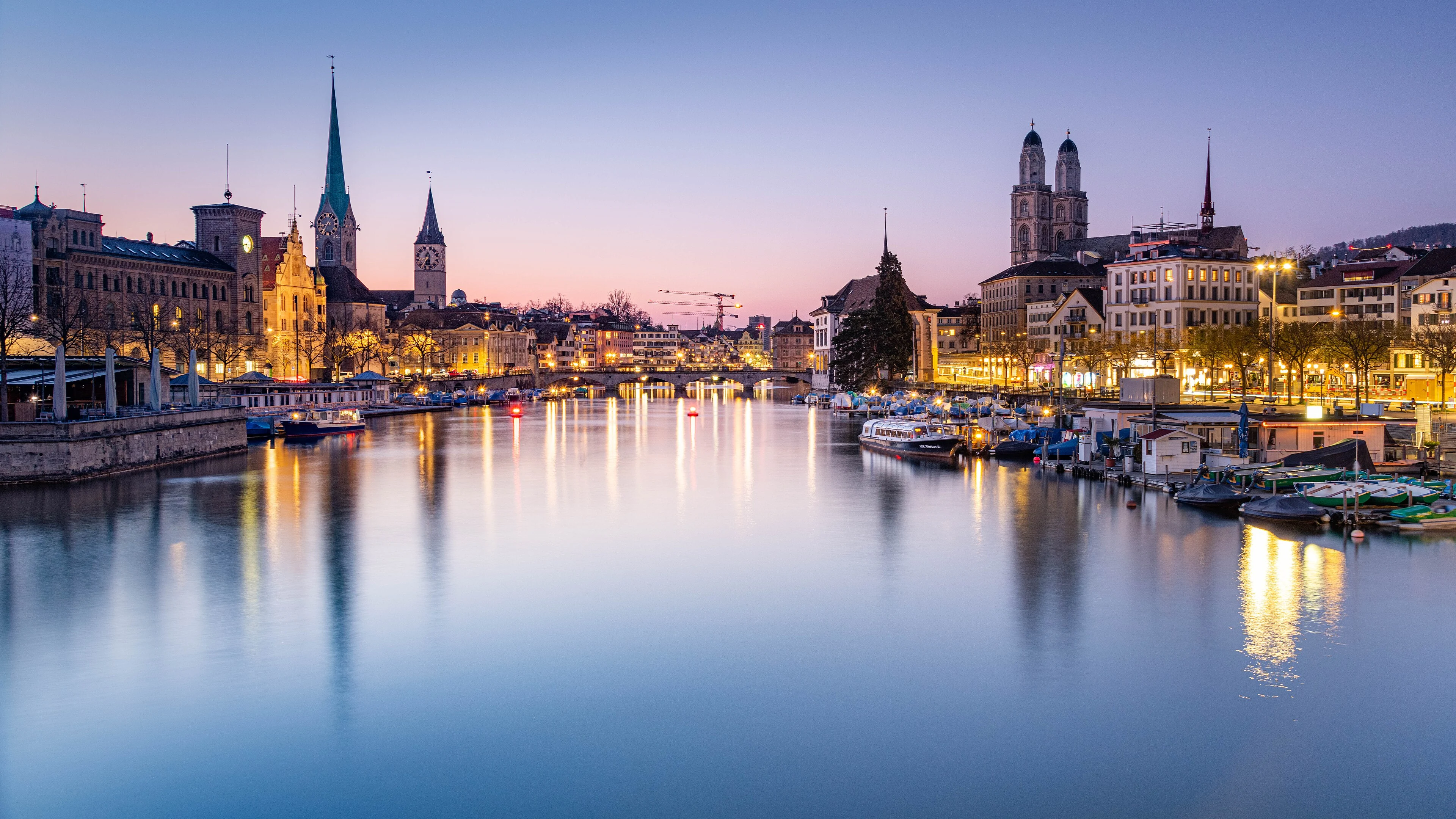 Zurich skyline and the Limmat River illuminated at blue hour